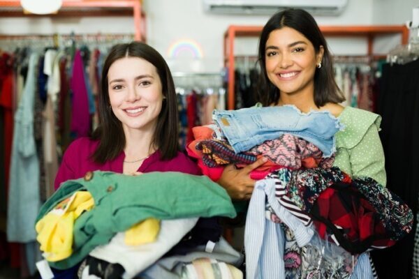 two women in a store holding clothes